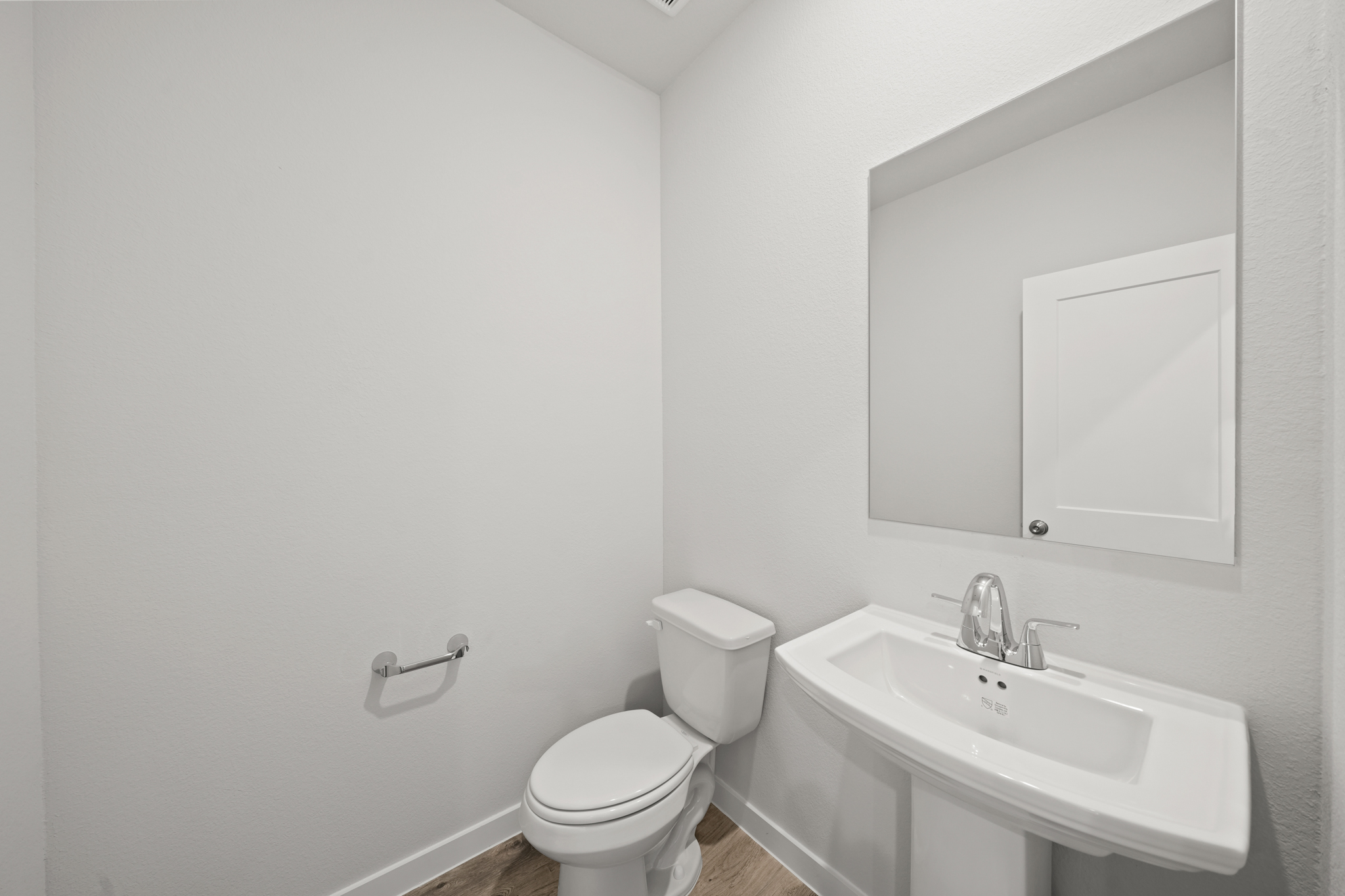 A bathroom with a toilet and sink.