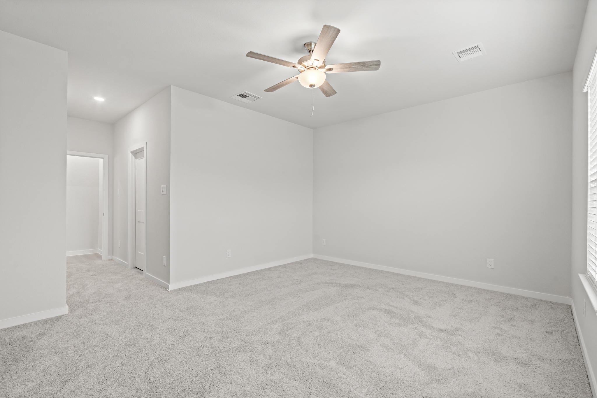 A room with a ceiling fan and a ceiling fan.