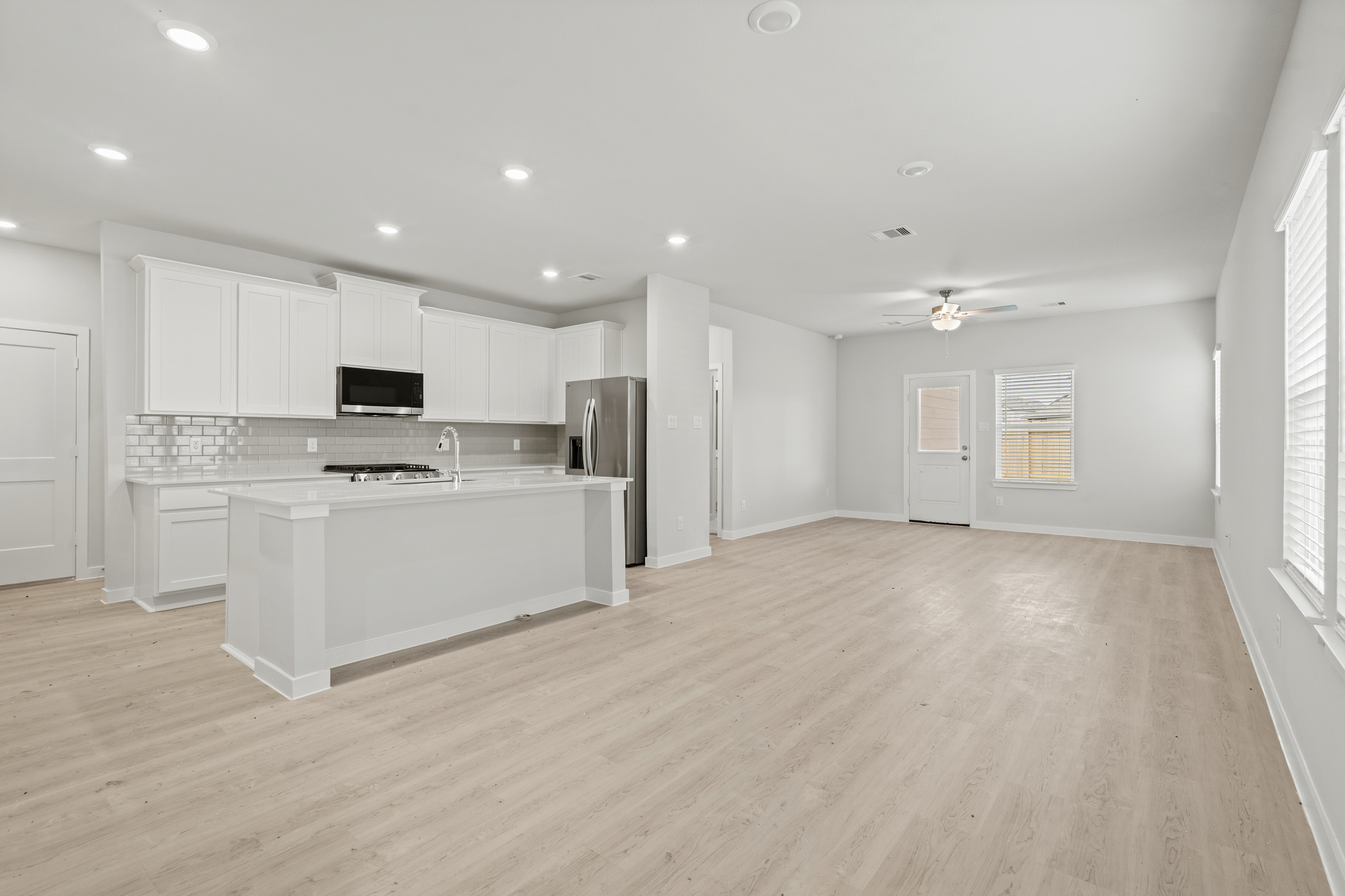 A large kitchen with white cabinets.