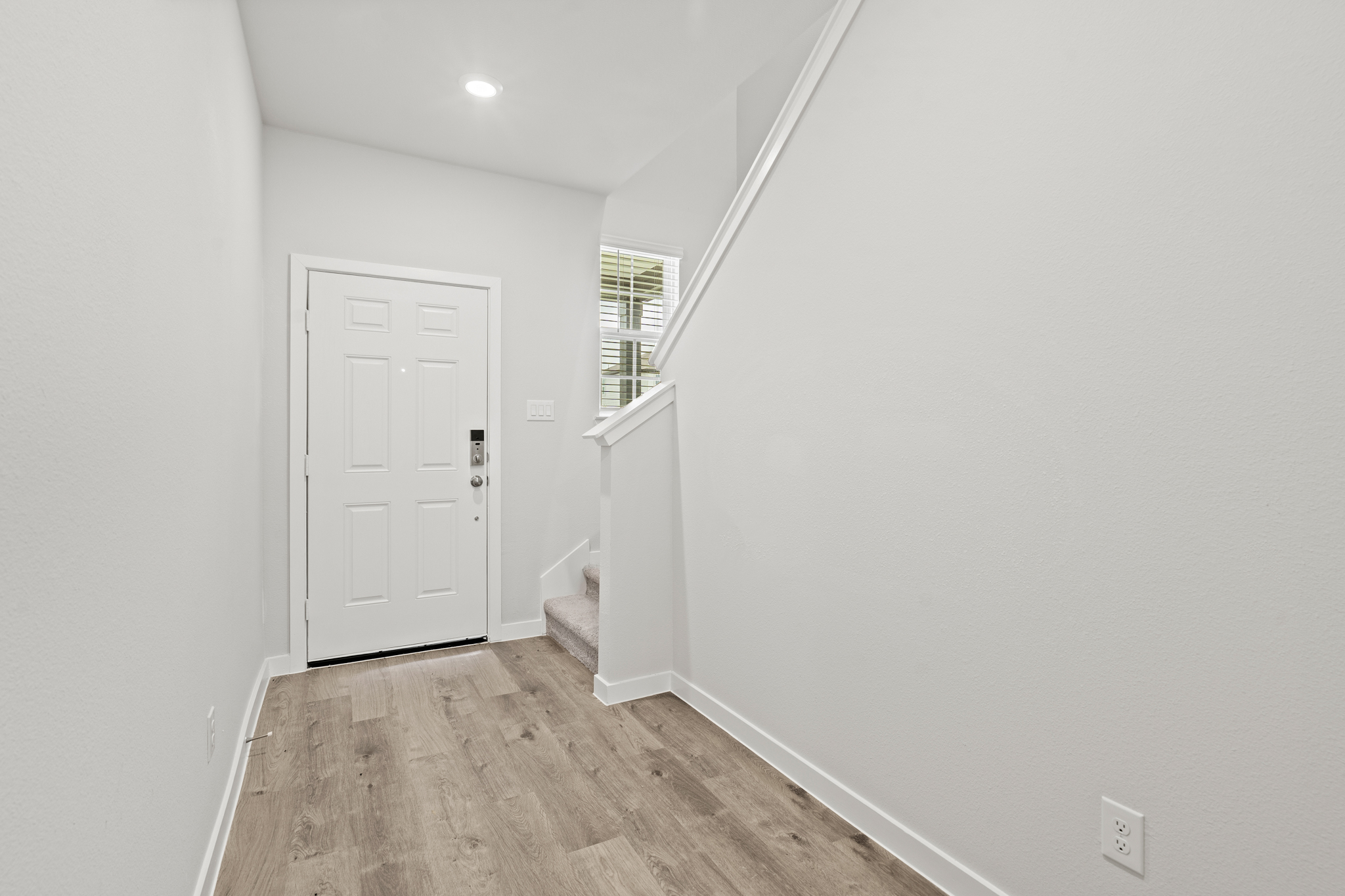 A hallway with white walls.