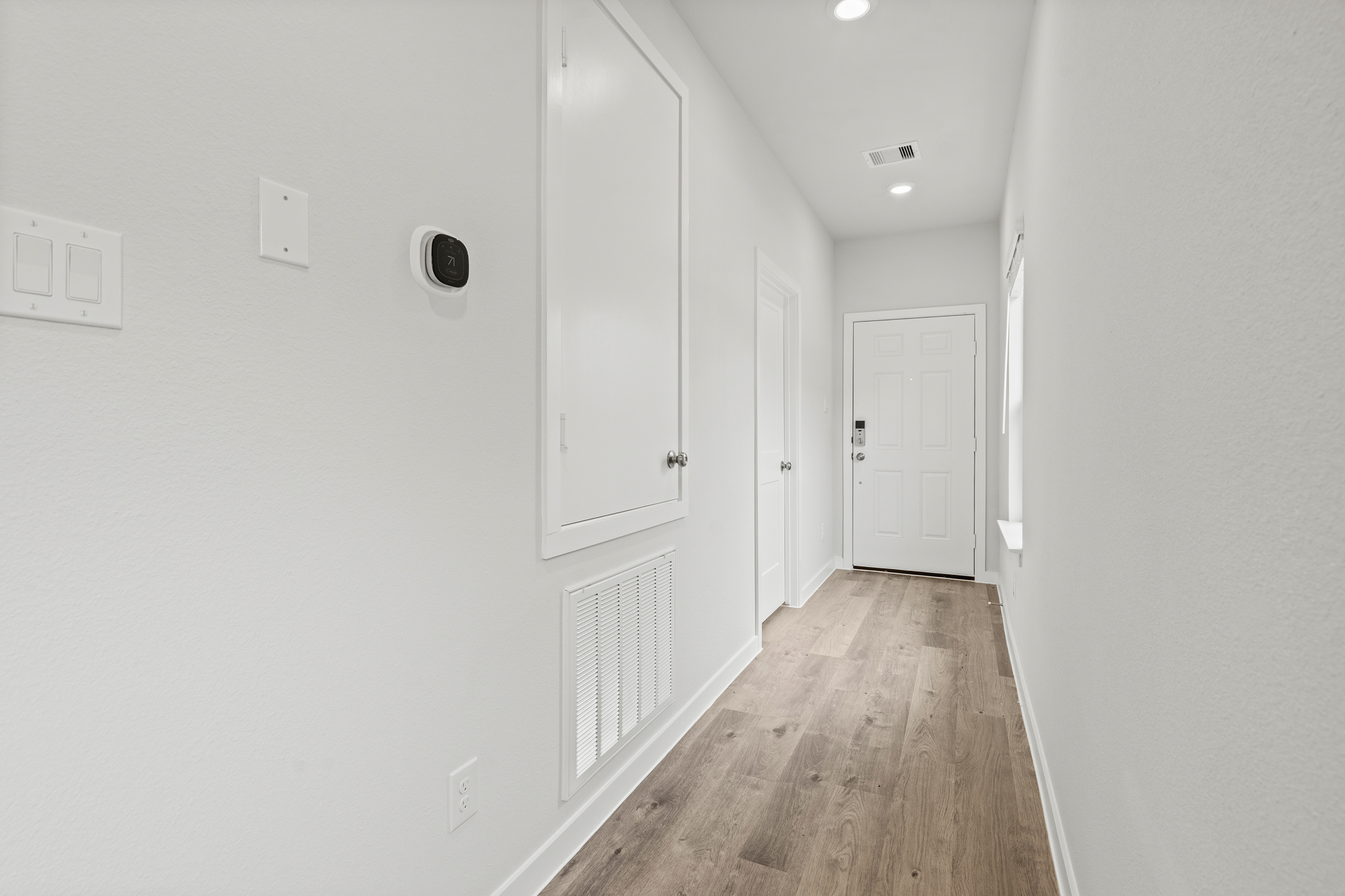 A hallway with white doors.