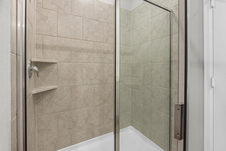 A shower with a glass door.