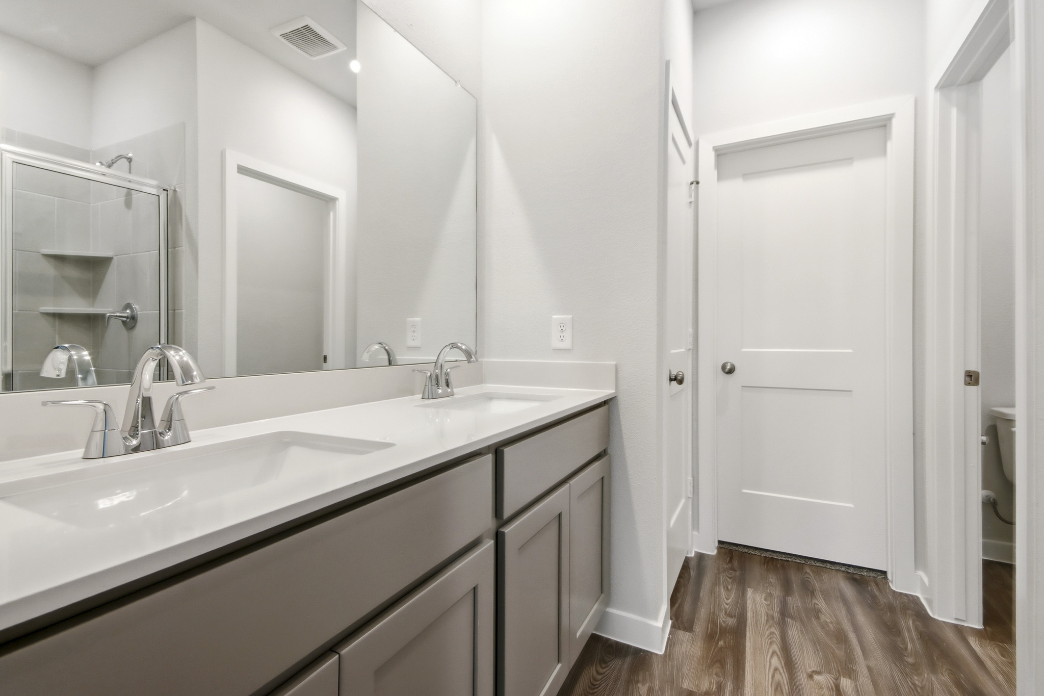 A bathroom with a large mirror.