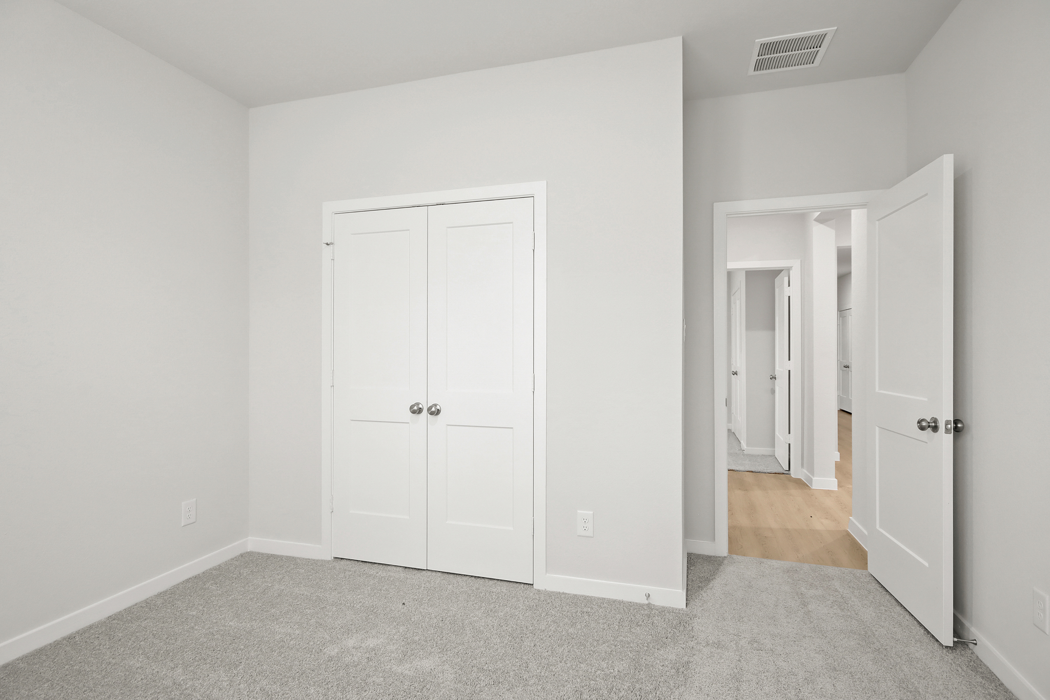A hallway with white doors.