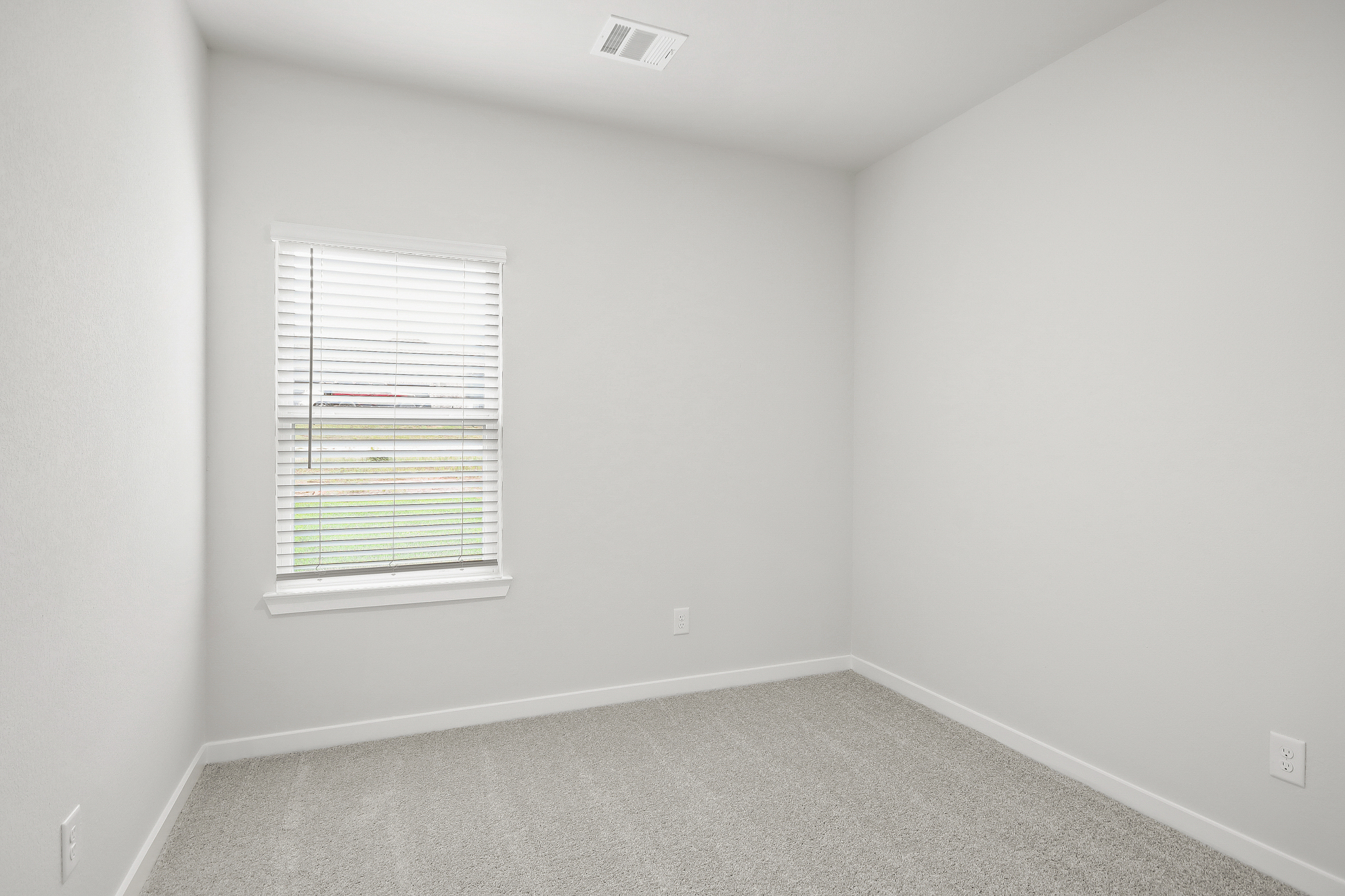 A room with a window and a vent.