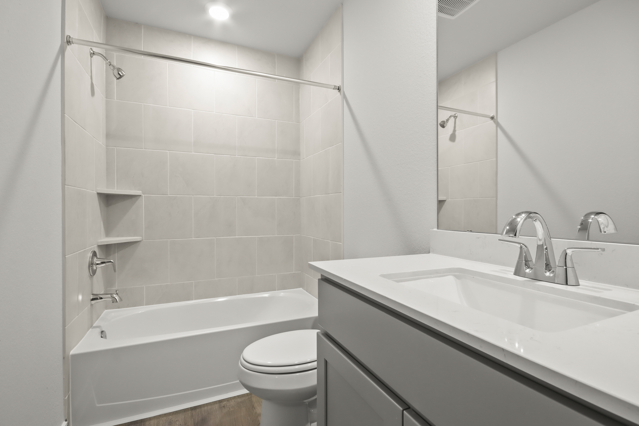 A bathroom with a tub sink and toilet.