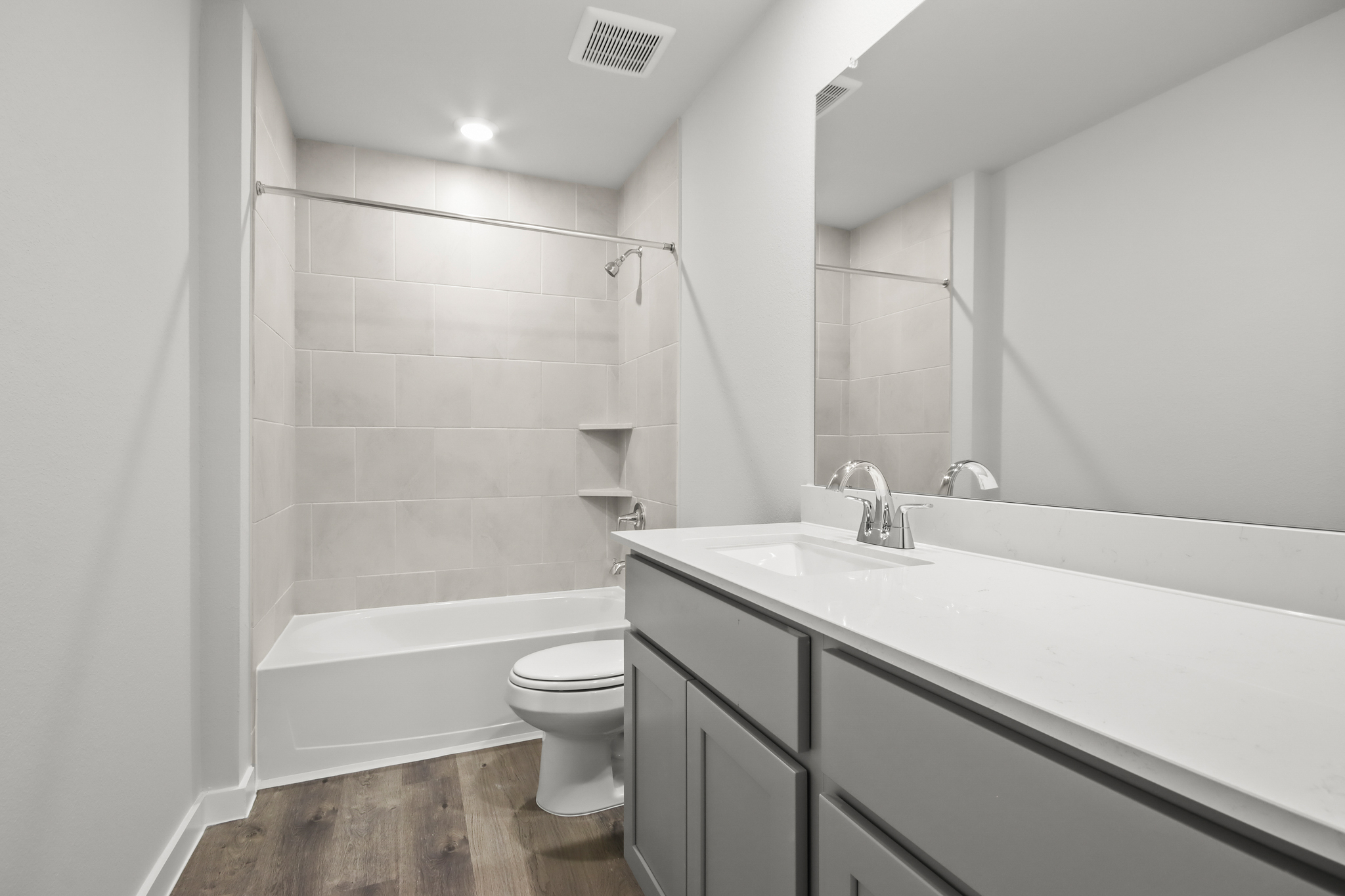 A bathroom with a tub toilet and sink.