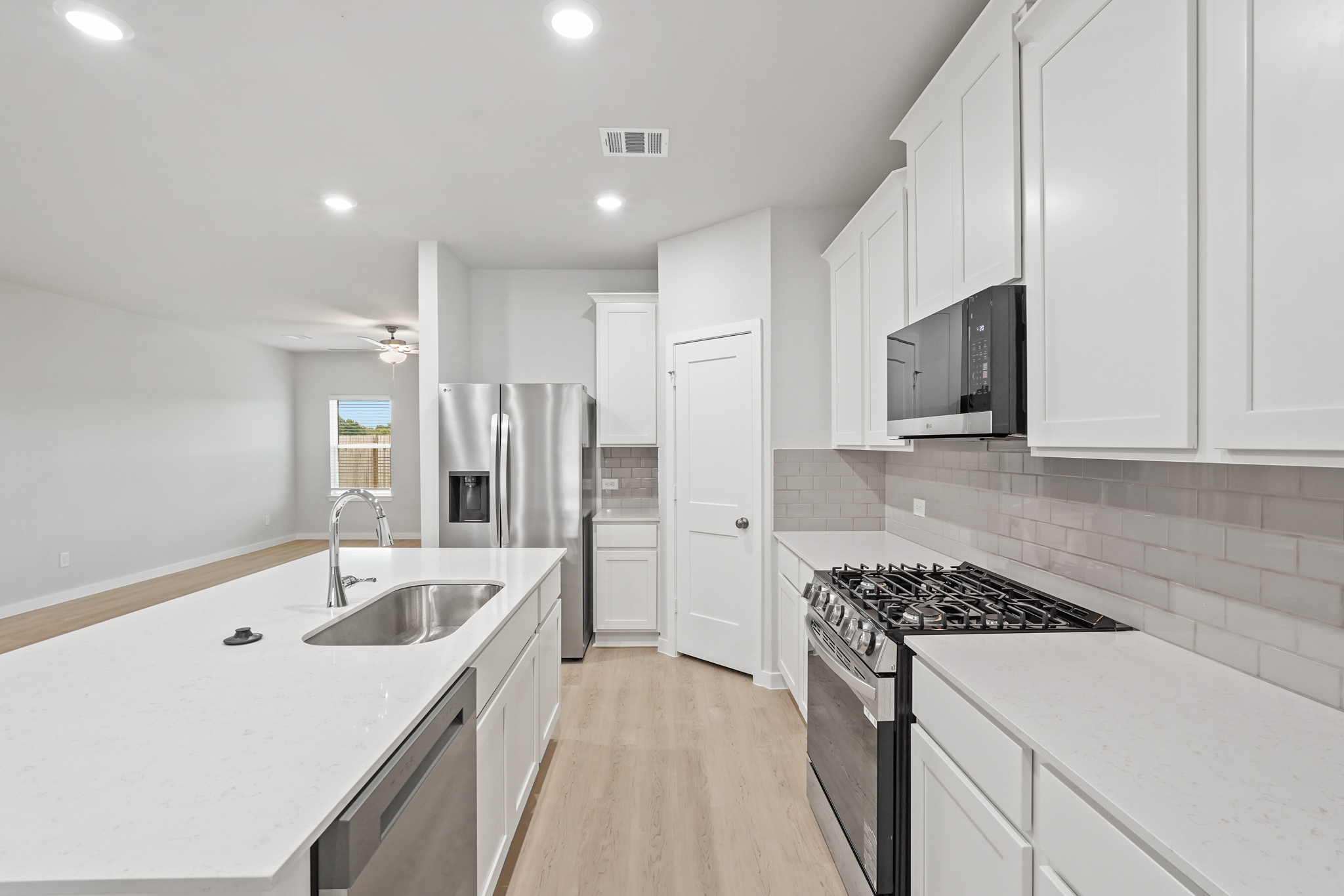 A kitchen with white cabinets.
