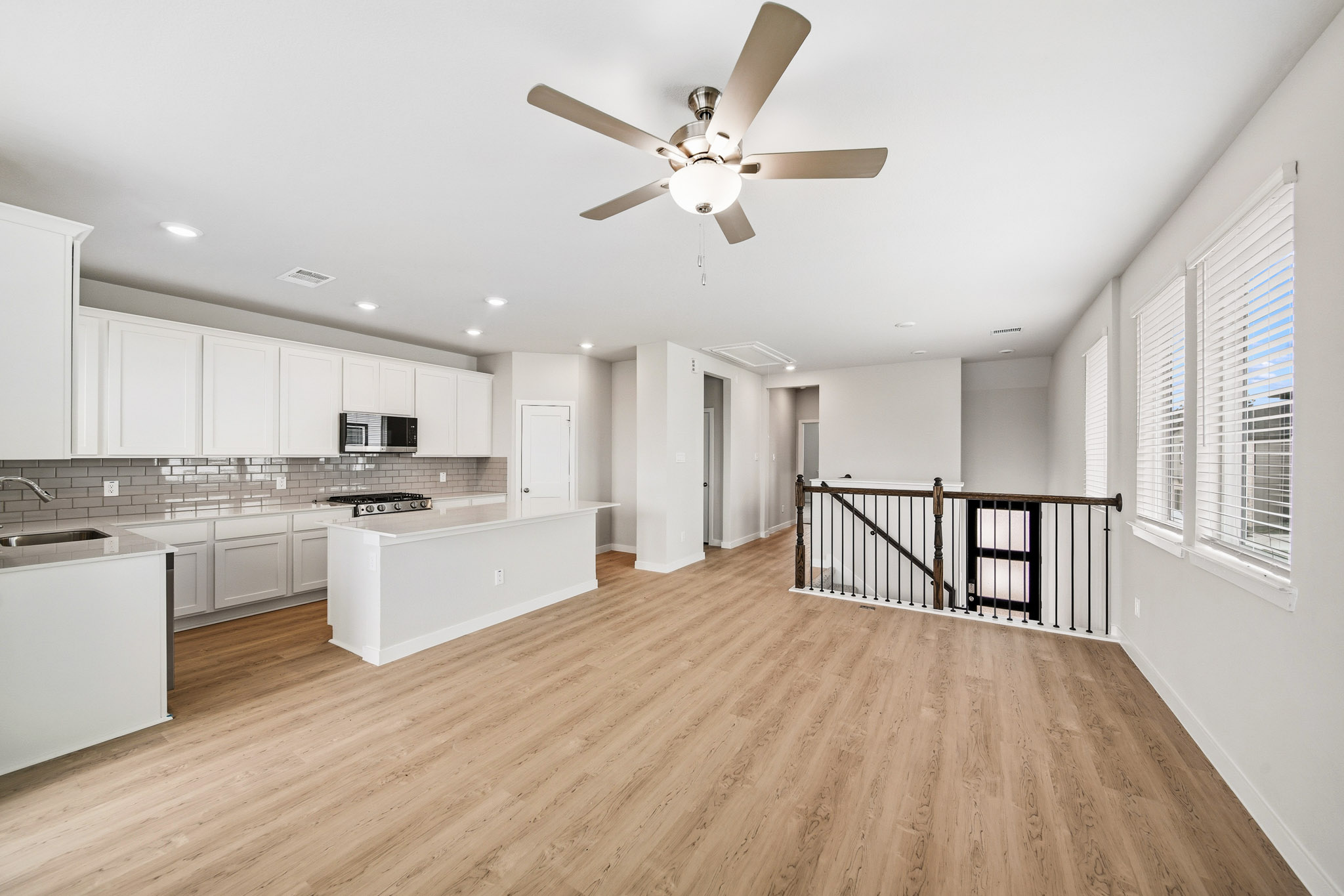 A kitchen with white cabinets.