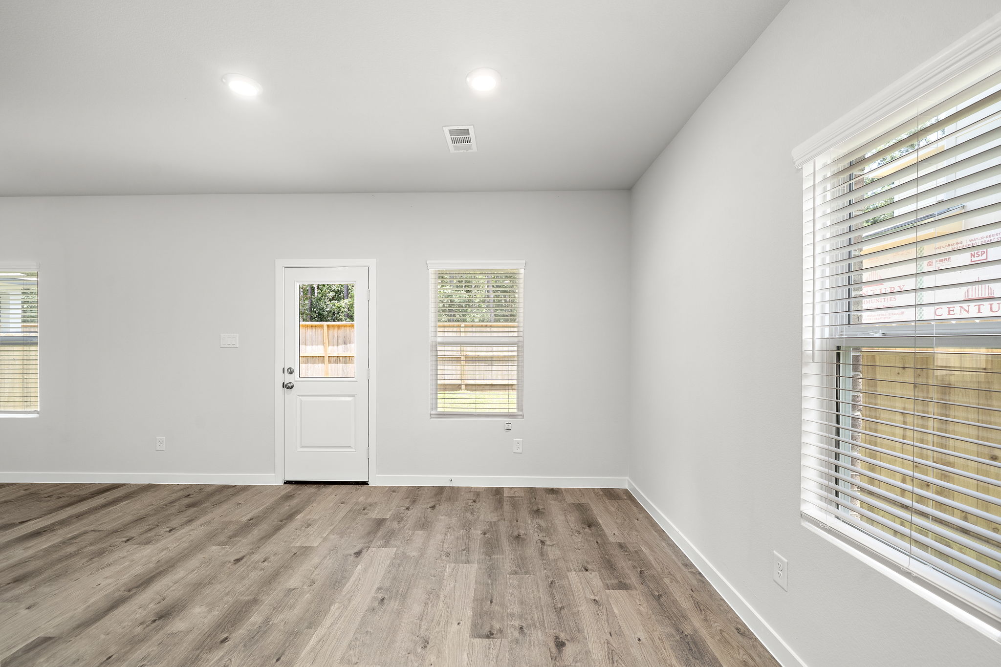 A room with a wood floor and a white door.