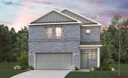 A house with a garage and trees.