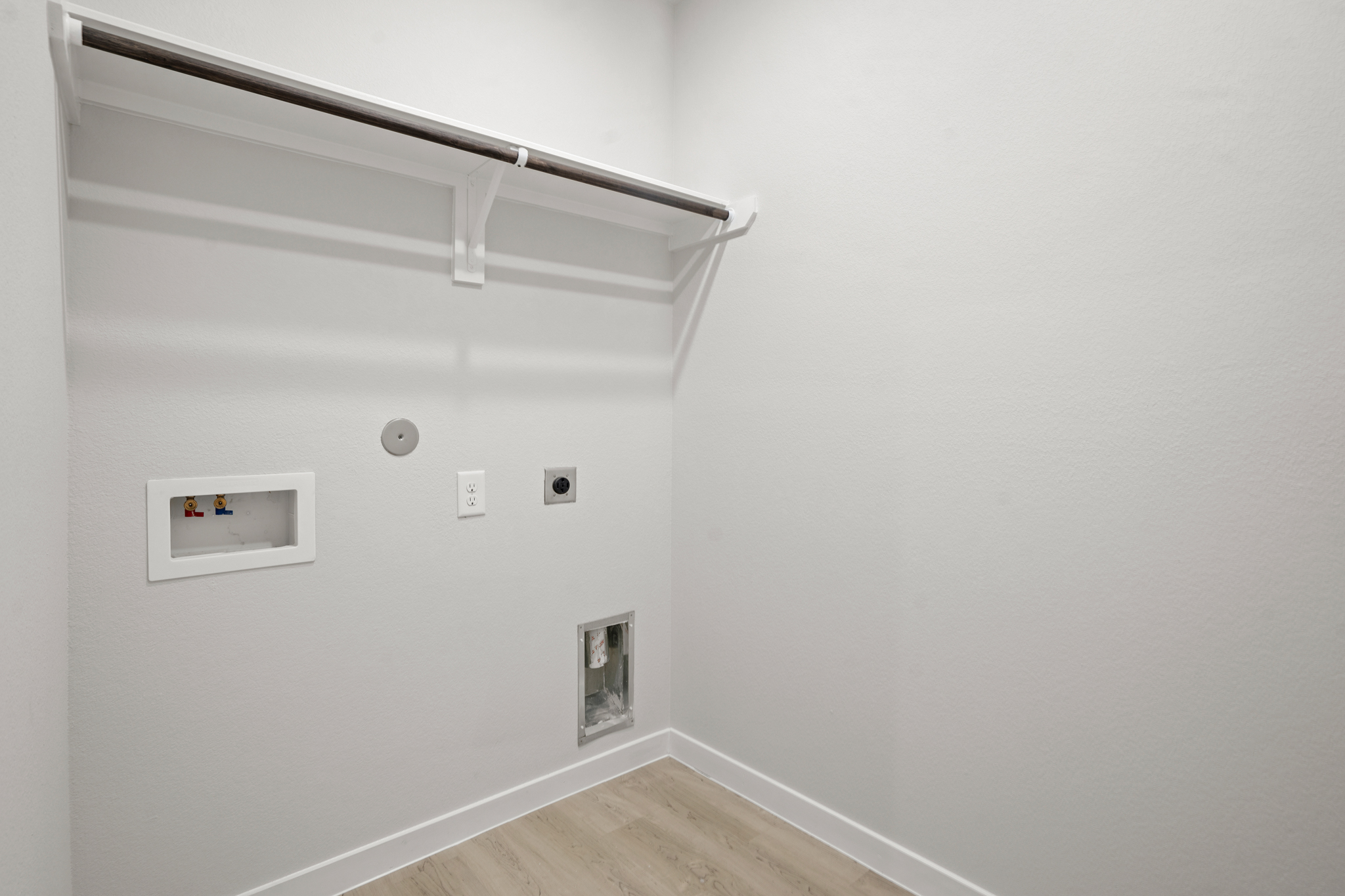 A white wall with a light fixture.