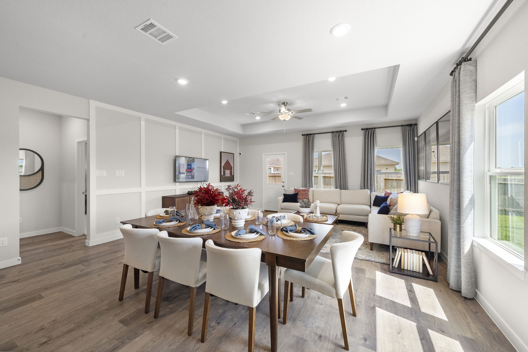 A dining room with a large table.