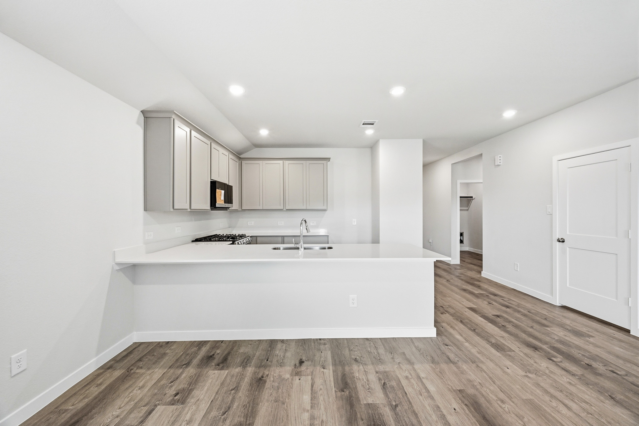 A kitchen with white cabinets.