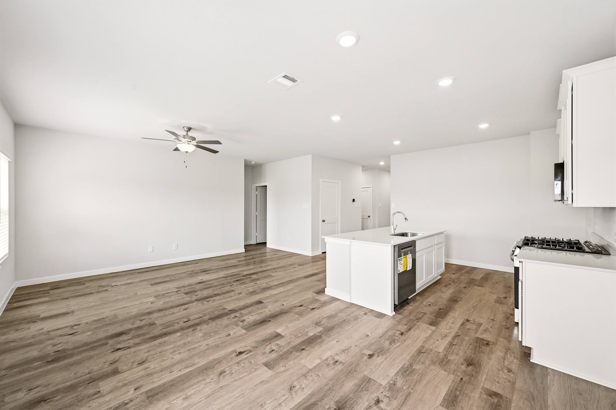 A kitchen with white cabinets.