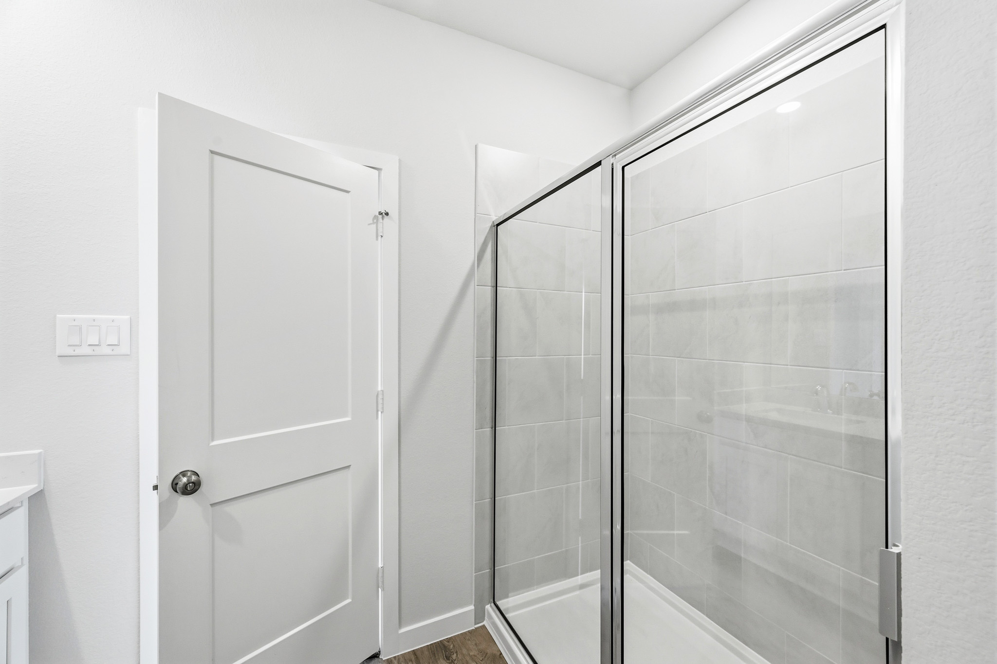 A shower with a glass door.