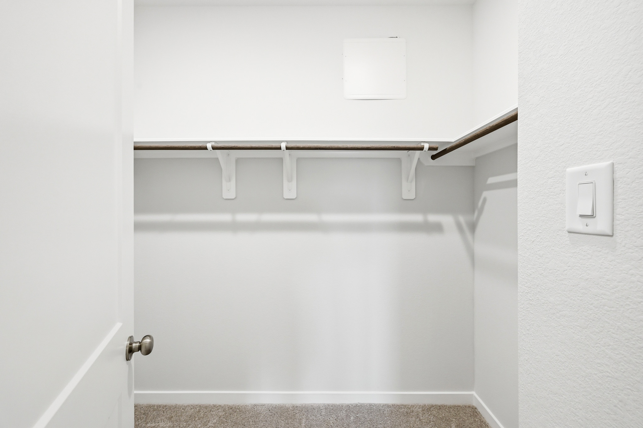 A white door with a metal bar.