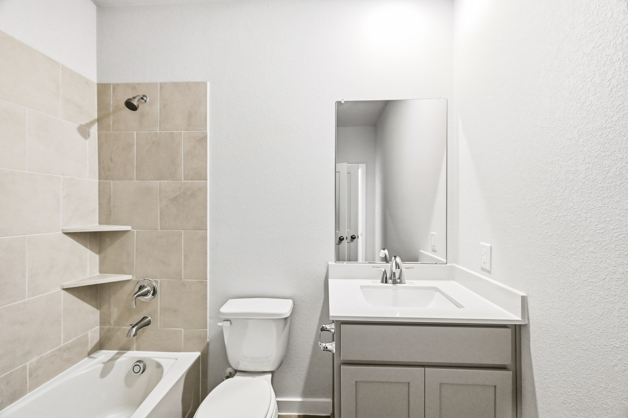 A bathroom with a sink toilet and bathtub.