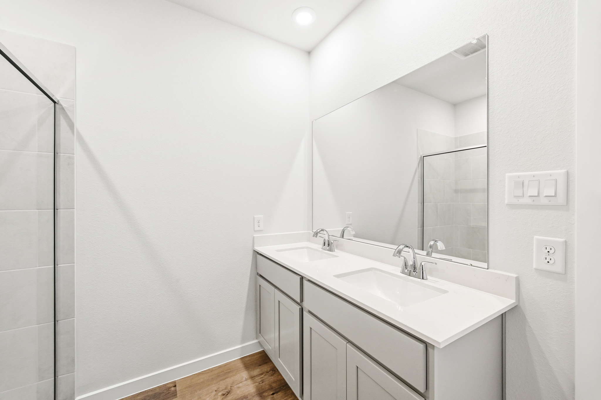 A bathroom with a large mirror.