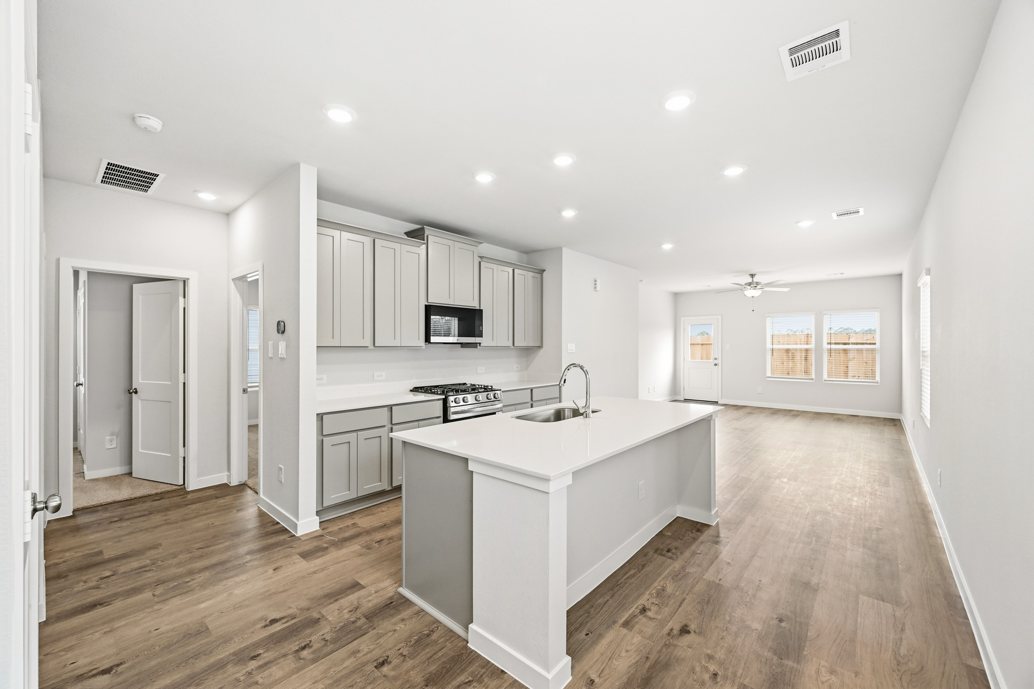 A kitchen with white cabinets.