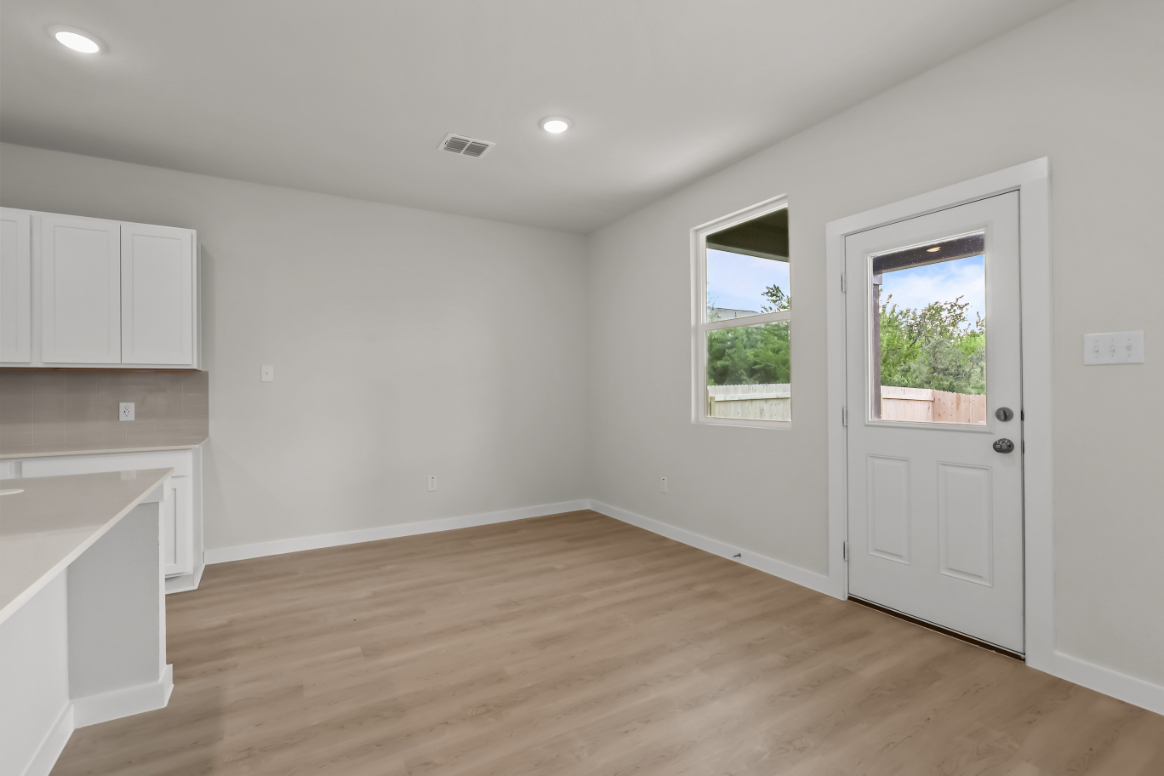 A room with white walls and a wood floor.