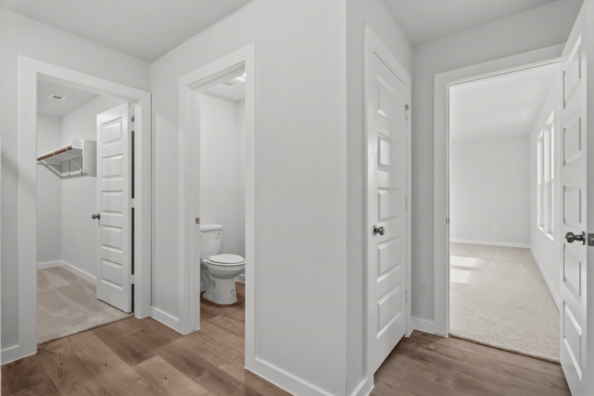 A bathroom with white doors.