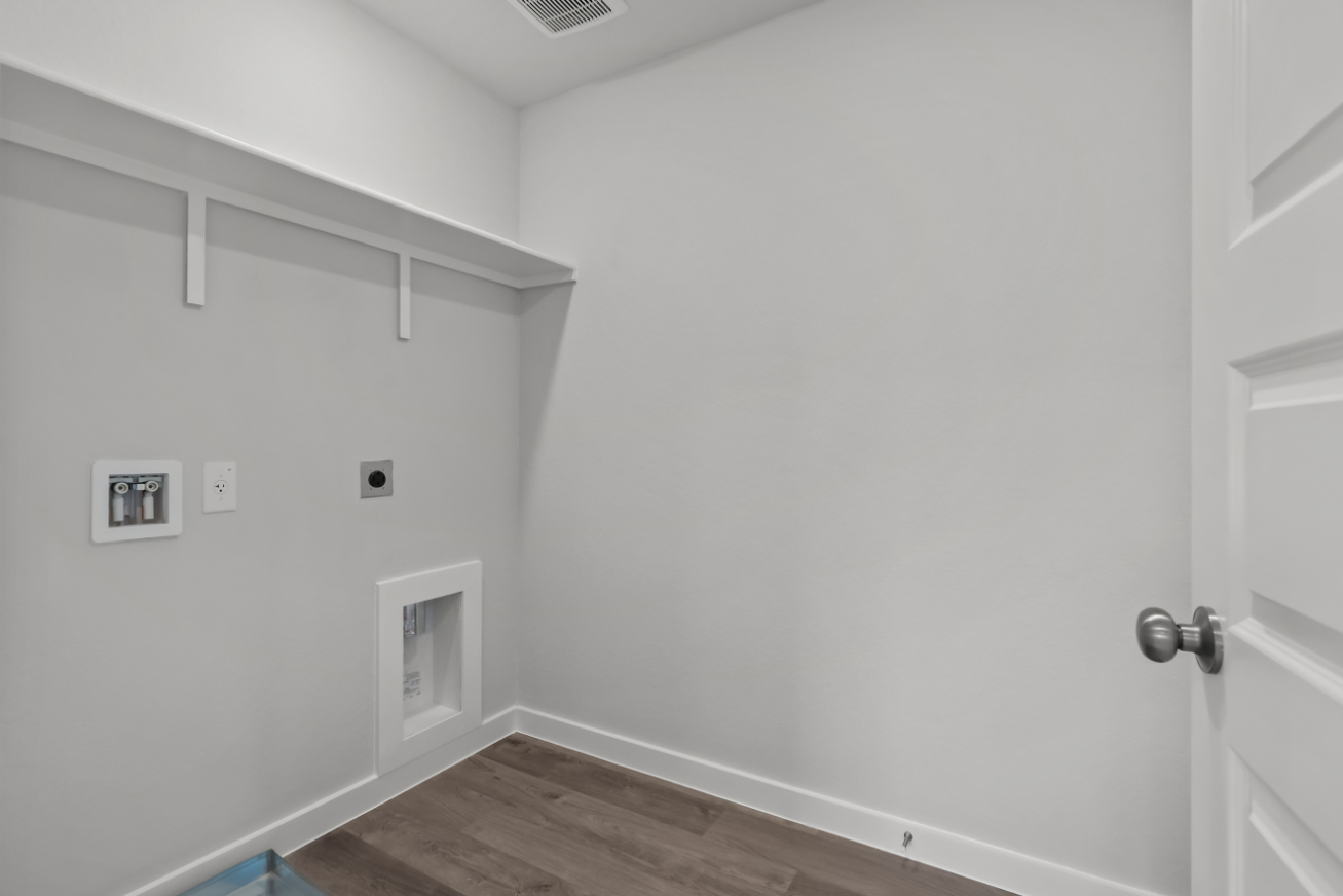 A white room with a wood floor.