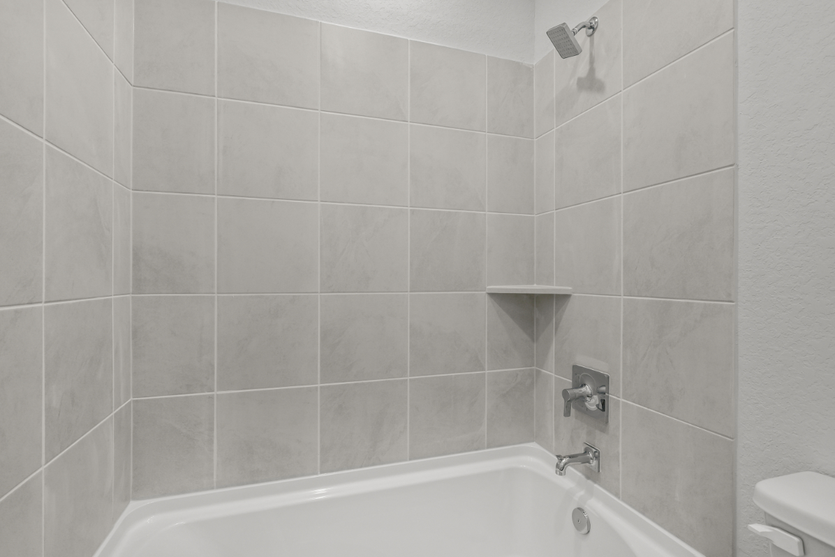 A bathroom with a bathtub and toilet.