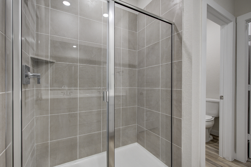 A shower with a glass door.