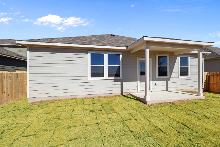 A house with a grass yard.