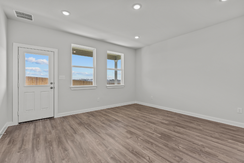 A room with a wood floor and white walls.