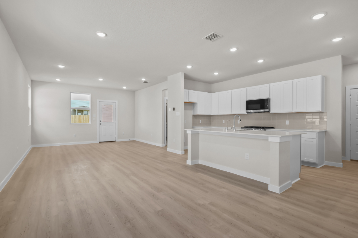 A large kitchen with white cabinets.