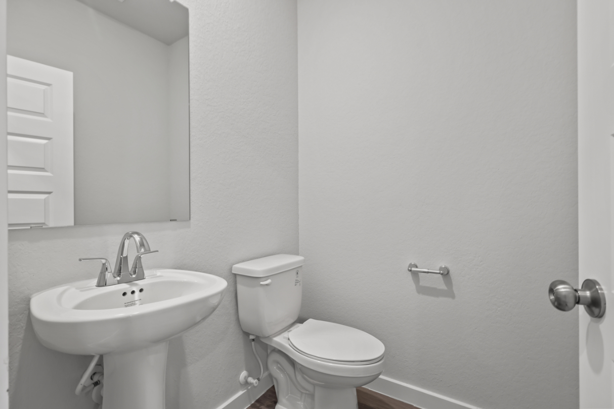 A bathroom with a toilet and sink.
