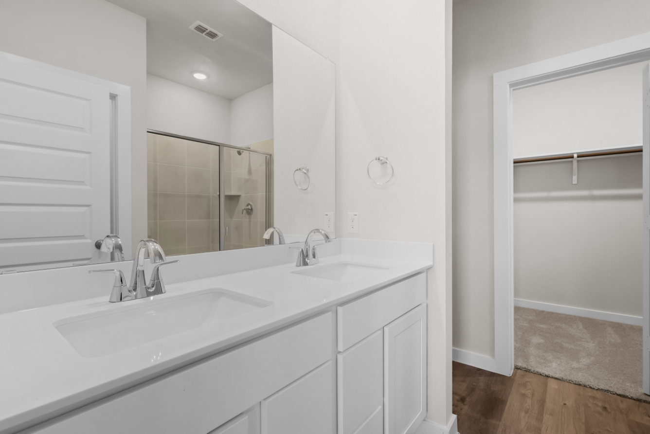 A bathroom with a large mirror.