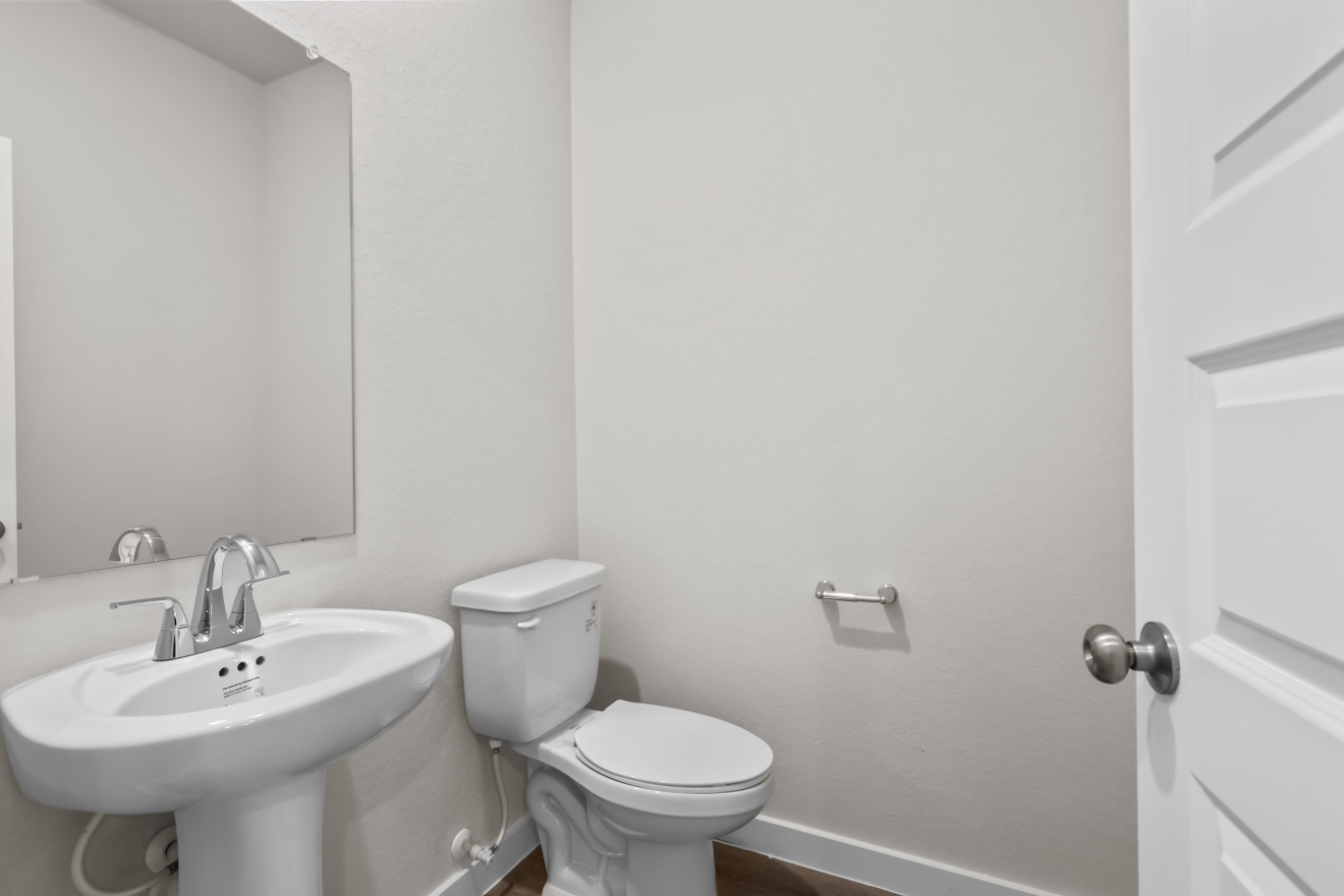 A bathroom with a toilet and sink.