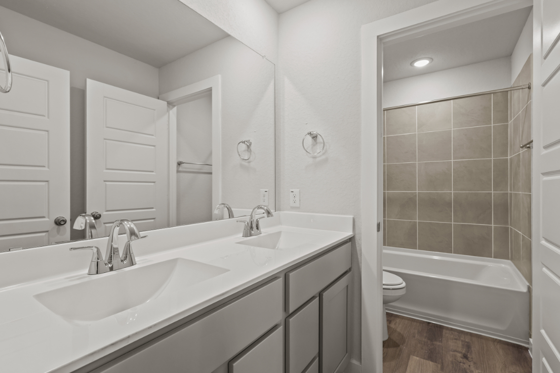 A bathroom with a tub sink and toilet.
