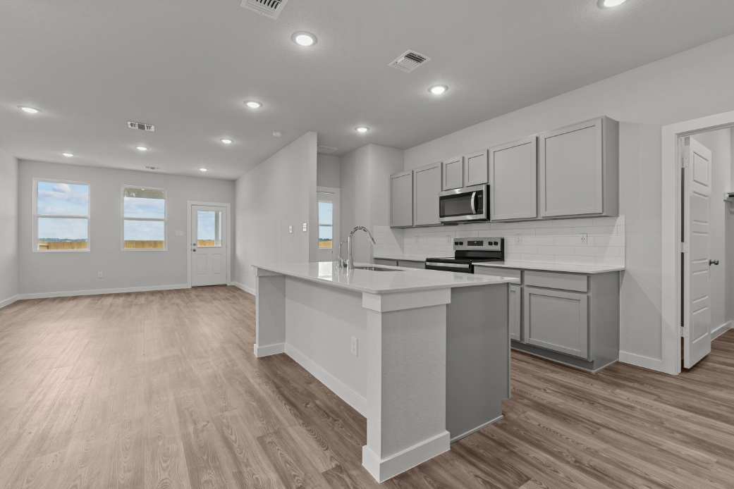 A kitchen with white cabinets.