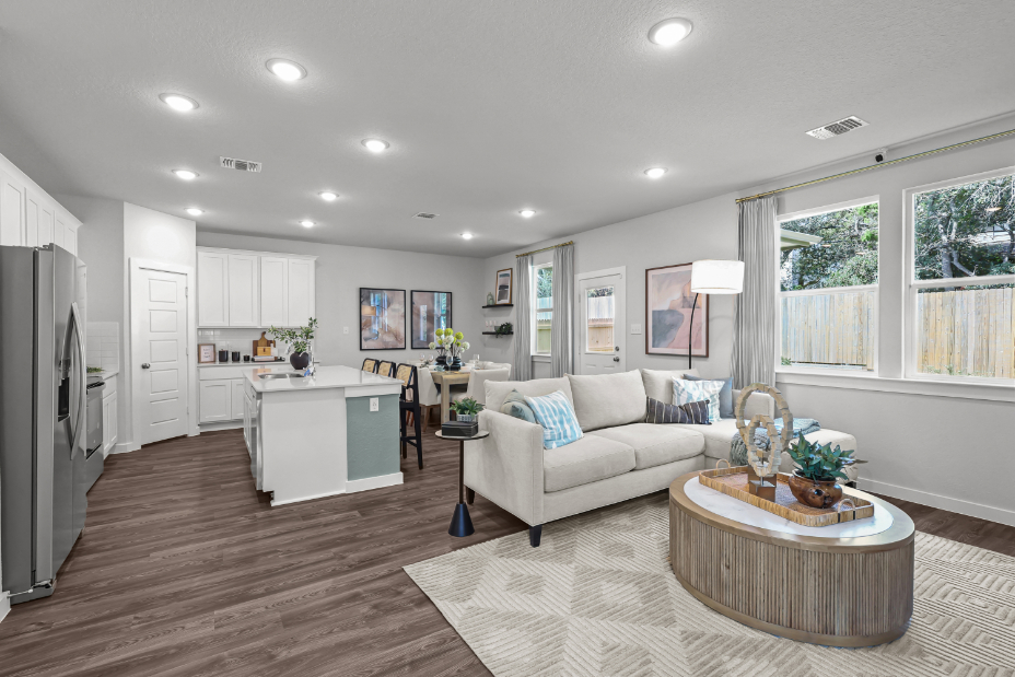 A living room with a white couch and a white table.