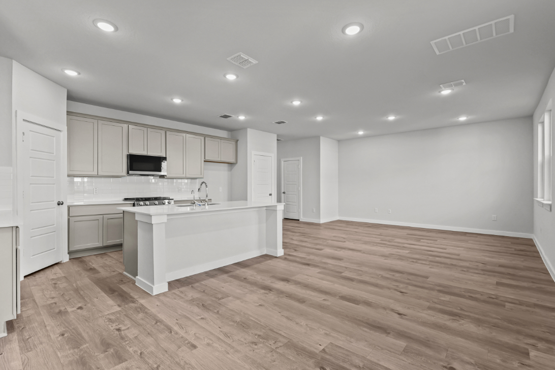 A kitchen with white cabinets.