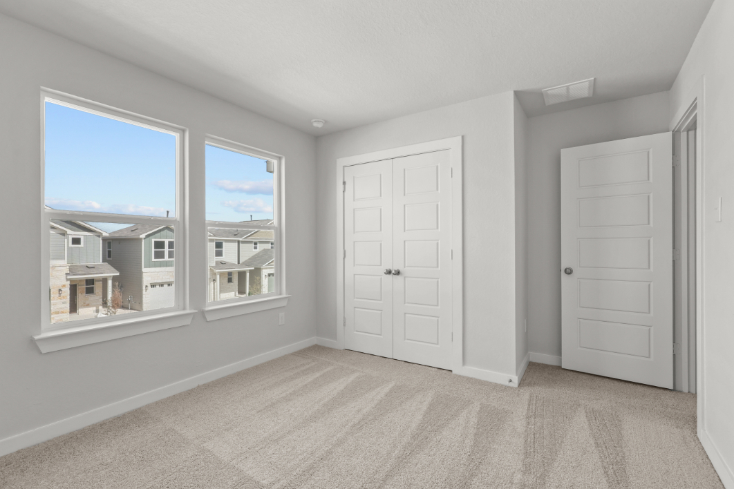 A room with white doors and a window.