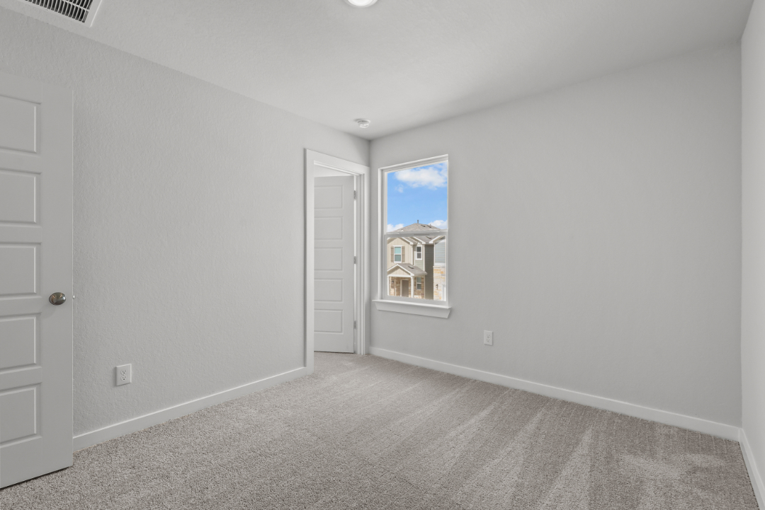 A room with a window and a door.