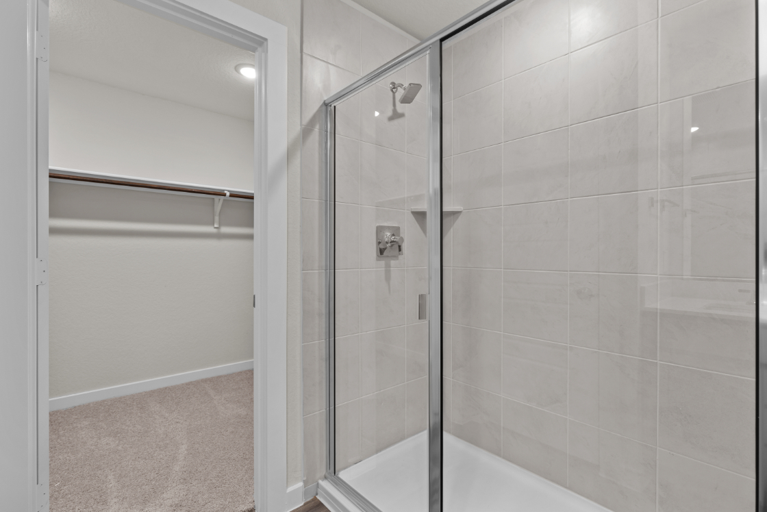 A shower with a glass door.