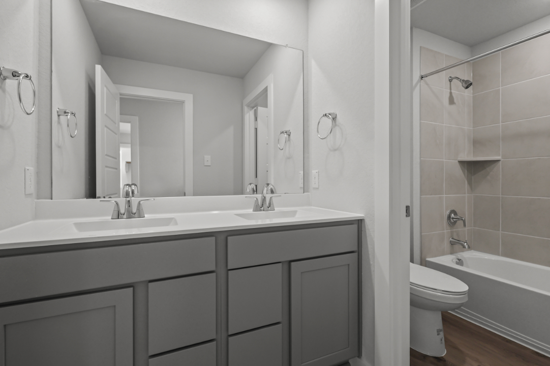 A bathroom with a tub sink and toilet.