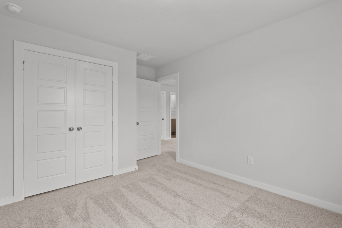 A hallway with white doors.