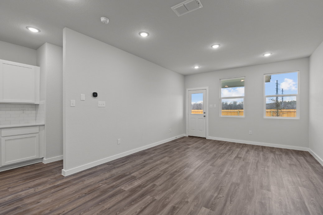 A room with white walls and a wood floor.