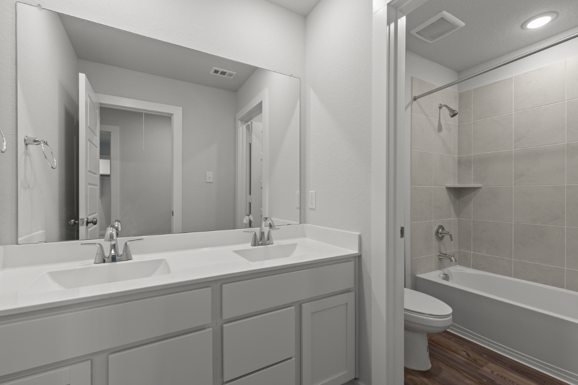 A bathroom with a tub sink and toilet.