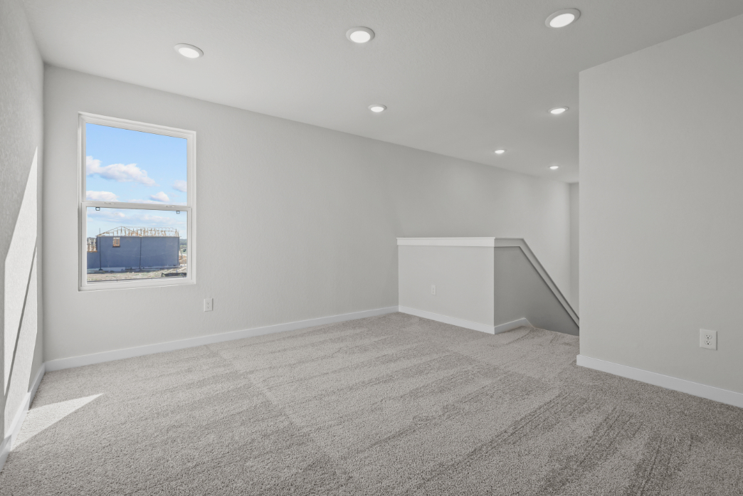 A room with a painting on the wall.