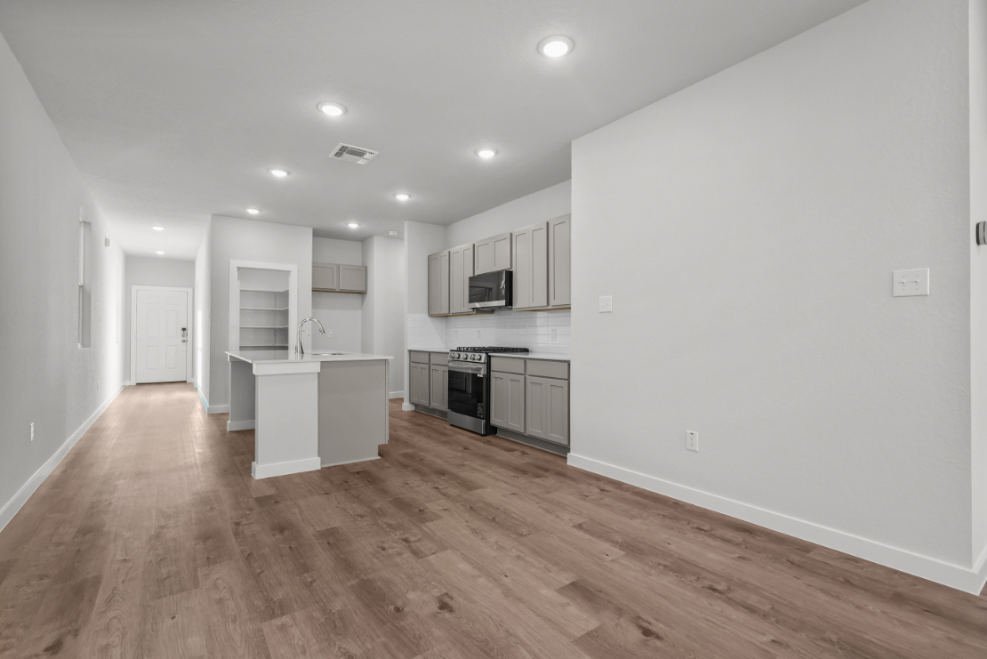 A kitchen with white walls.