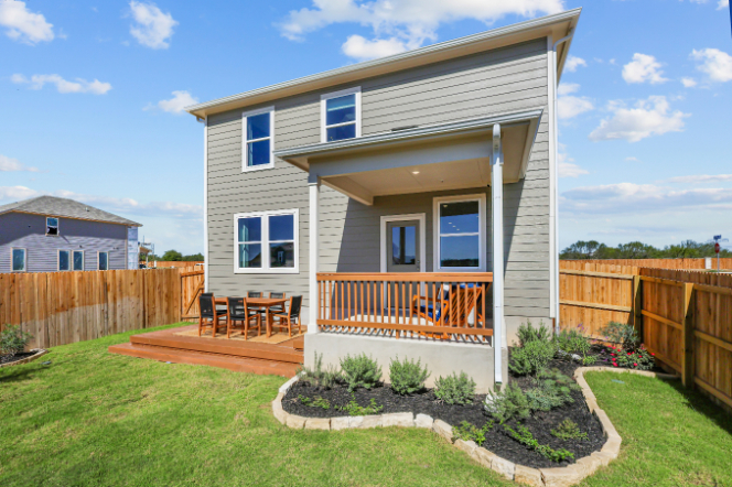 A house with a fence and yard.