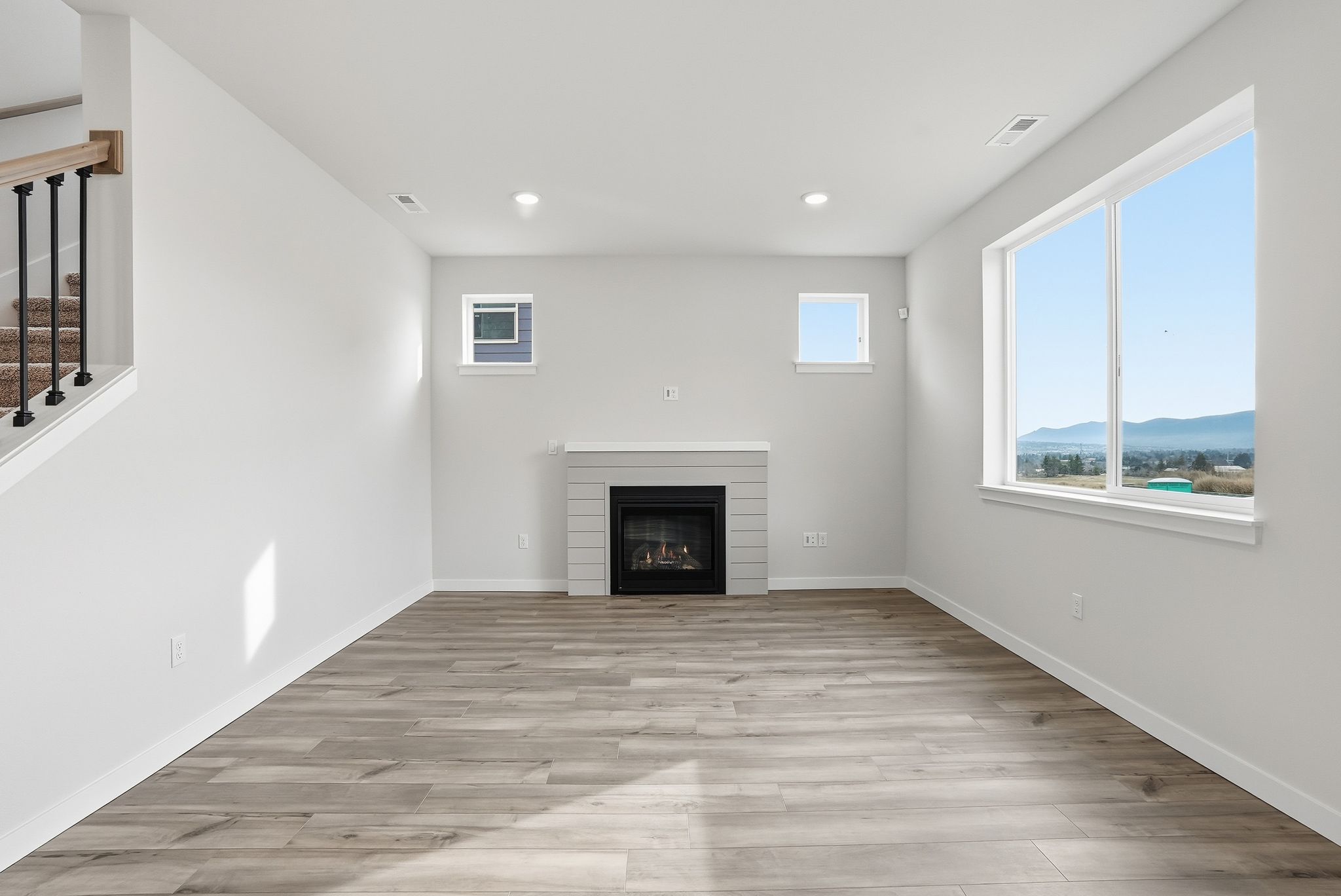 A room with a fireplace and windows.